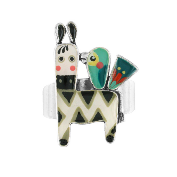 Image of ring with black & white alpaca and teal bird.