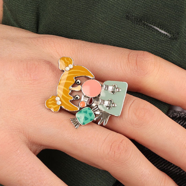 Image of model wearing quirky ring featuring blonde haired girl blowing bubble gum all hand painted in multicoloured resin on silver plated finish.