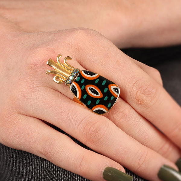 Image of model wearing pineapple shaped ring hand painted in multicolours with precious stones and beads gold plated finish.