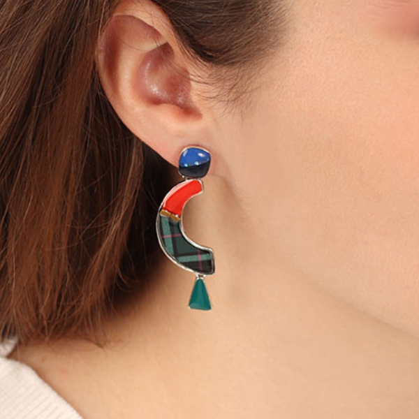 Image of model wearing multi coloured half moon dangle stud earrings.