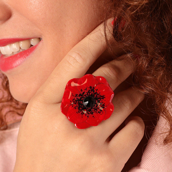 Image of model wearing cute red hand painted poppy ring with rhinestone centrepiece.